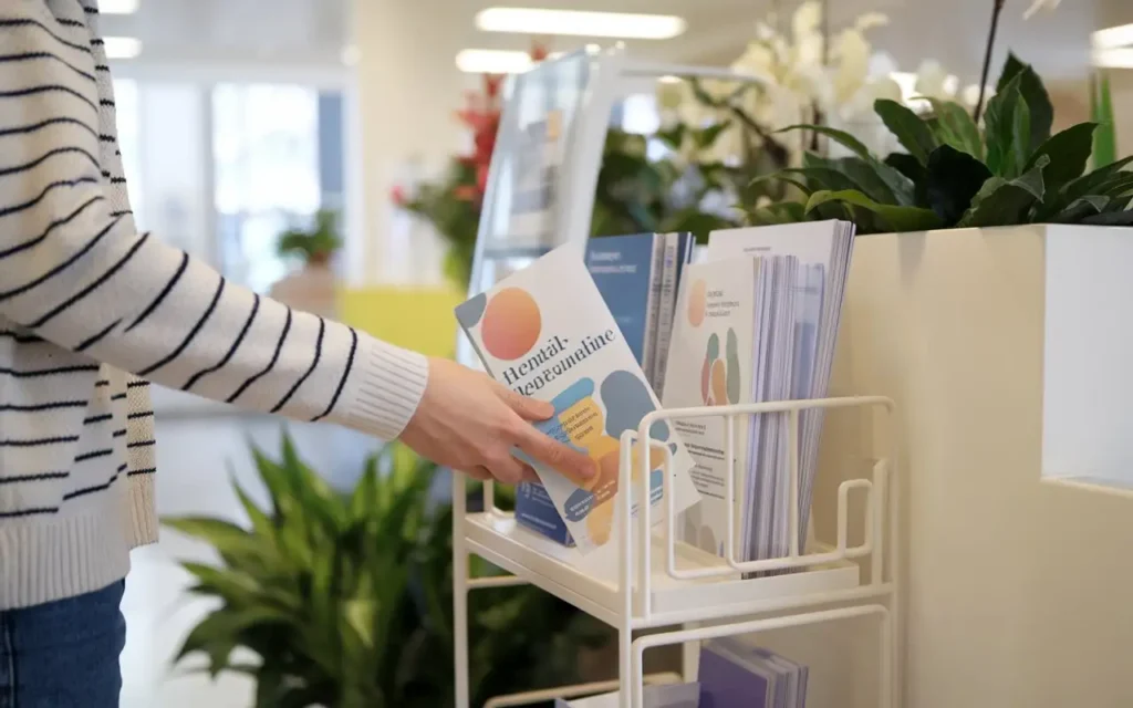 Person finding mental health pamphlets in a clinic