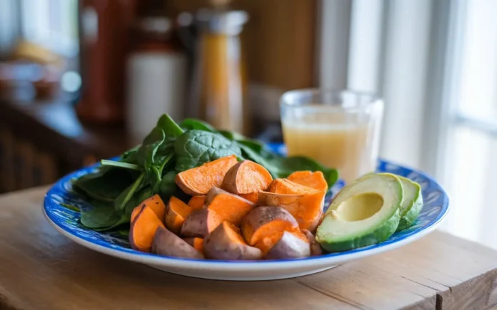 A delicious AIP diet breakfast plate featuring sweet potatoes, avocado, and greens