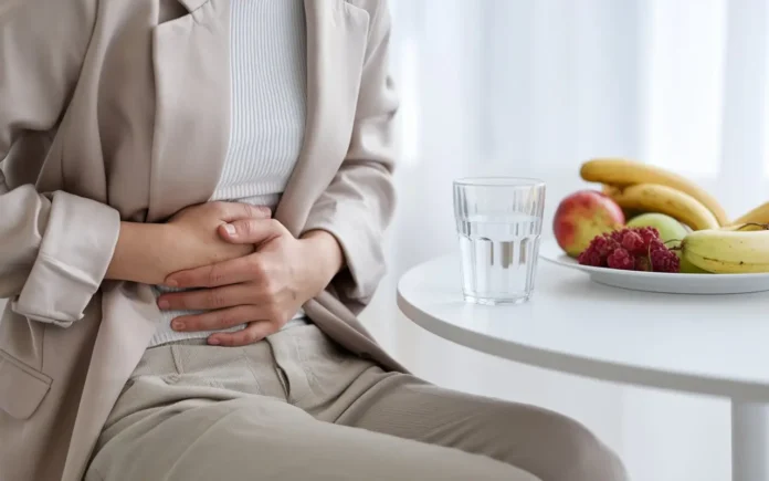 A person holding their stomach while fasting, with a focus on digestive health.