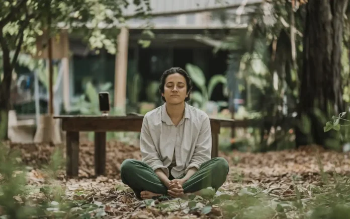 A serene person meditating outdoors, symbolizing the mental clarity achieved by fasting from social media.