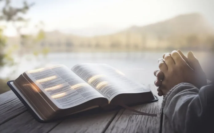 Fasting scriptures for breakthrough Bible open with prayer hands