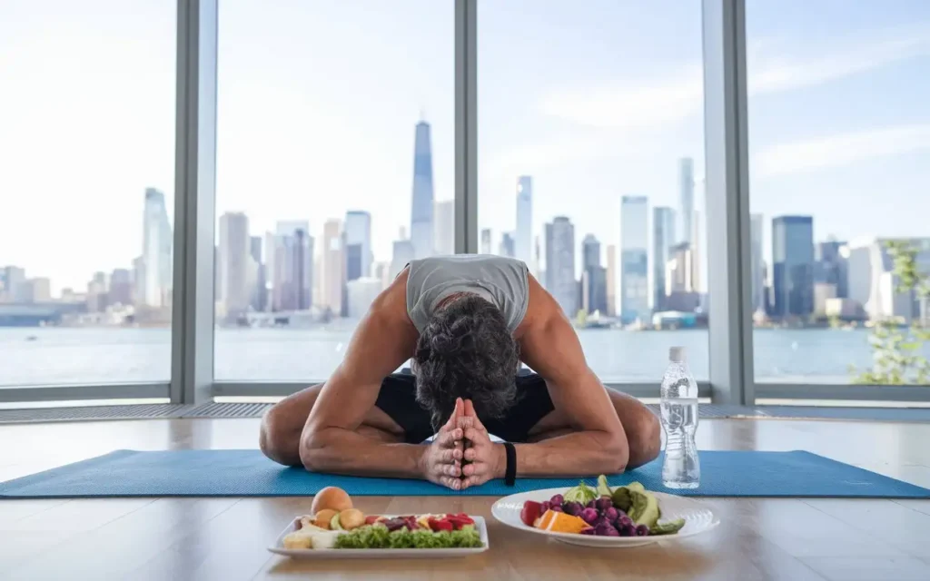 A person exercising with a healthy meal nearby.
