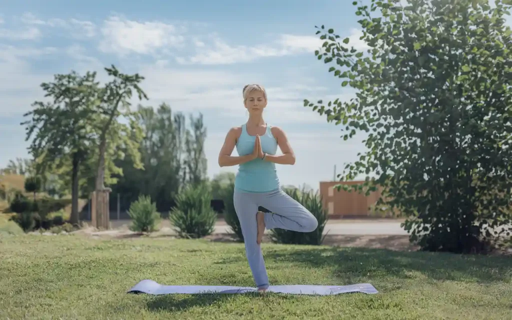 A middle-aged woman doing yoga to complement intermittent fasting during menopause.