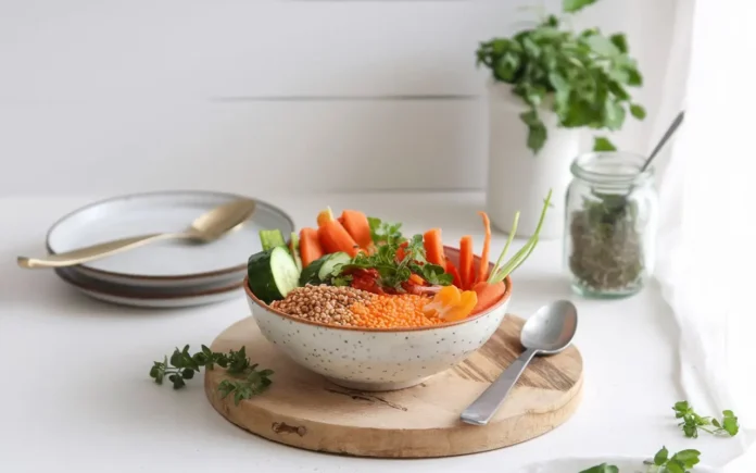 A bowl of assorted millets for weight loss with fresh vegetables and herbs