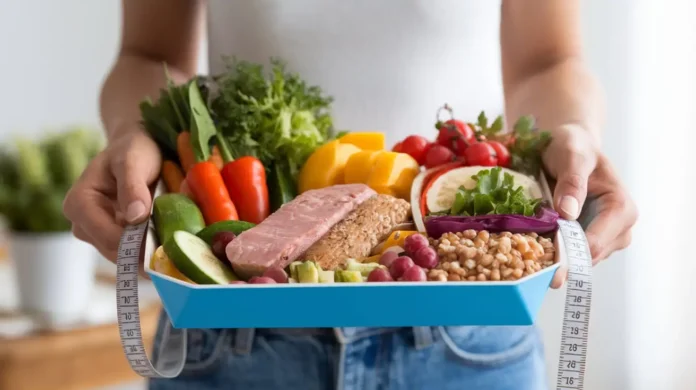 A person holding a healthy meal tray as part of the phentermine diet plan.