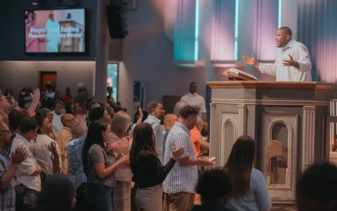 A pastor delivering a prayer and fasting sermon to a congregation