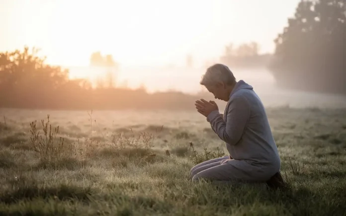 A serene image of hands folded in prayer with soft sunlight filtering through, symbolizing prayers for fasting.