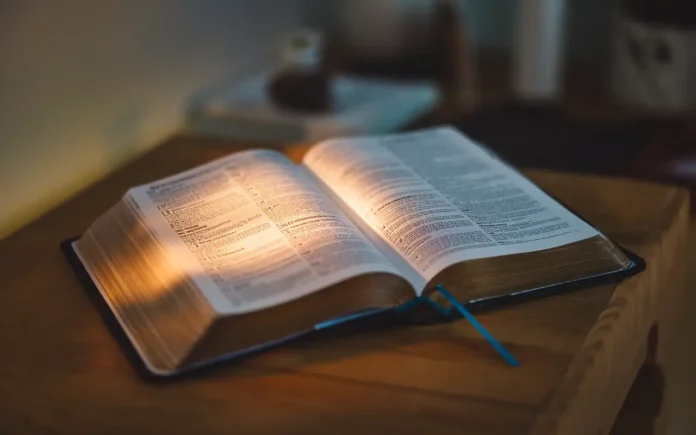 A Bible open to Isaiah 58 with a soft glow, symbolizing scripture for fasting