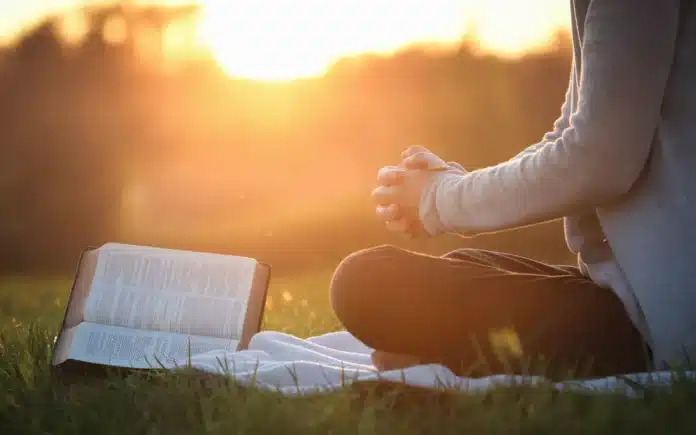 A serene image of a person praying and fasting in a peaceful setting, representing the transformative power of sermons on fasting