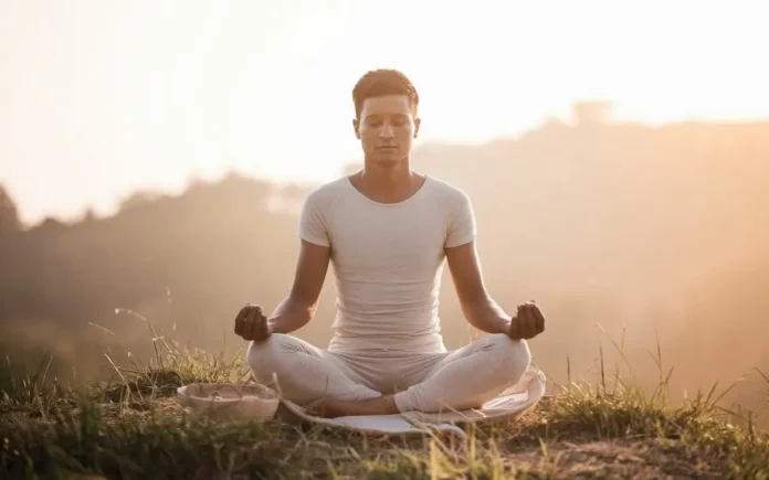 A serene individual meditating outdoors, symbolizing the spiritual benefits of fasting