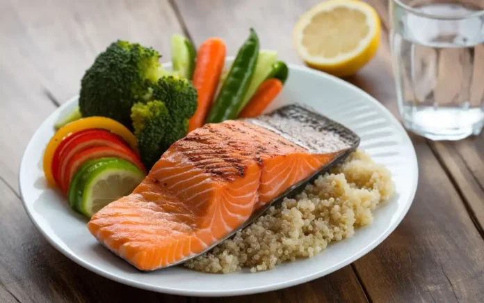 A balanced meal with colorful fresh vegetables and salmon representing the vestibular migraine diet.