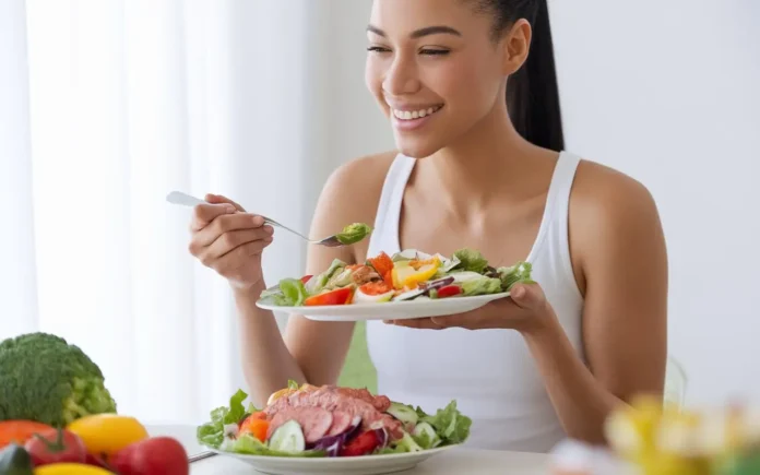 Woman enjoying a healthy salad as part of a pcos diet meal plan