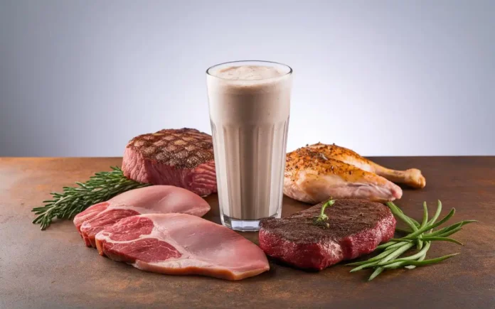 A tall glass of protein shake against a backdrop of meats, highlighting protein shakes on carnivore diet